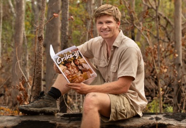 Robert Irwin Readong on a Log