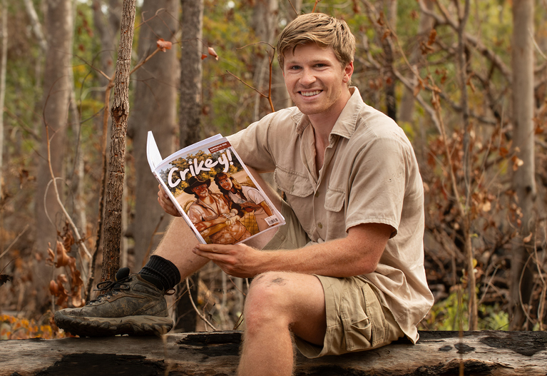Robert Irwin Readong on a Log